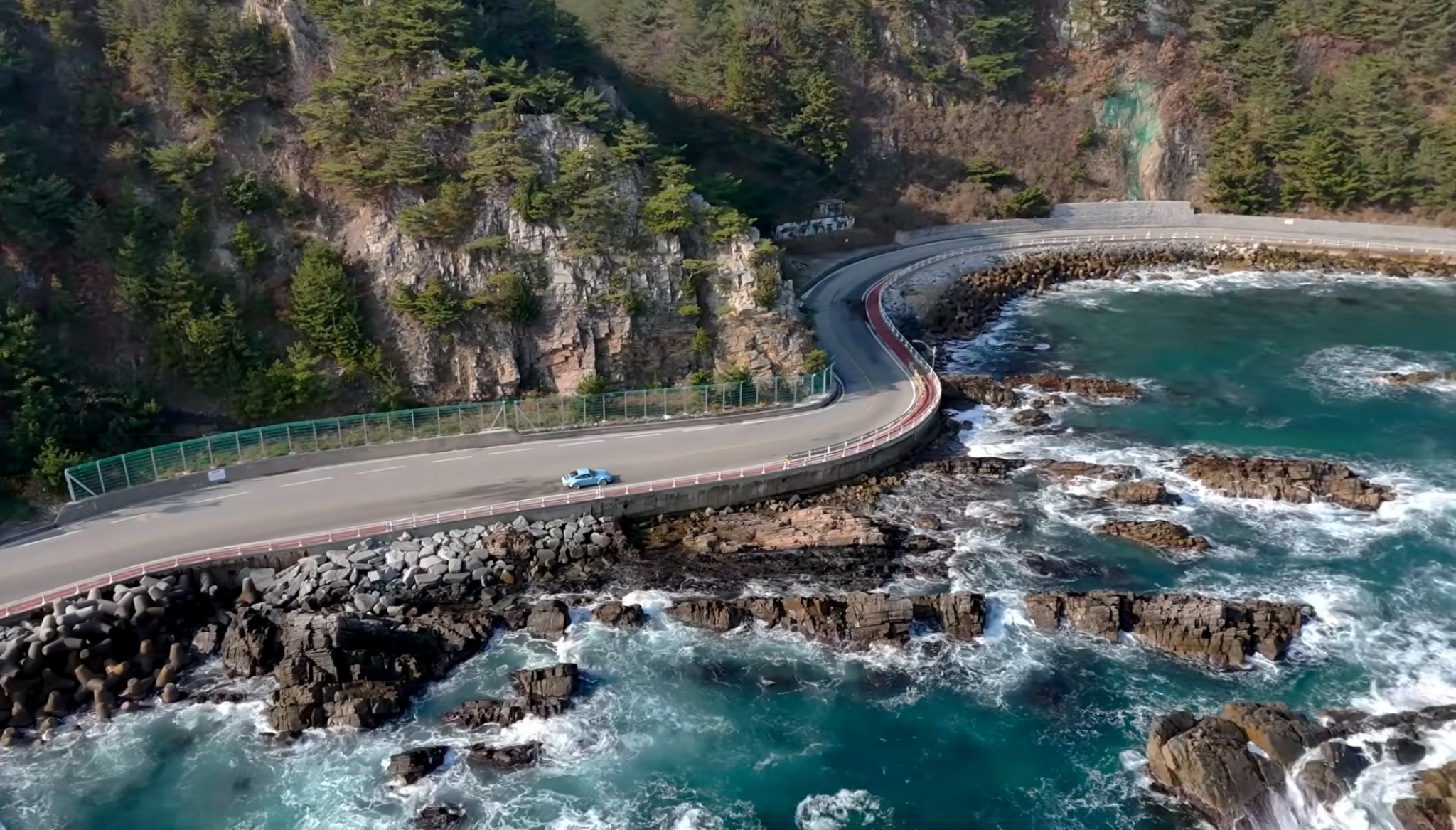 HANGANG driving a winding coastal road beside the sea